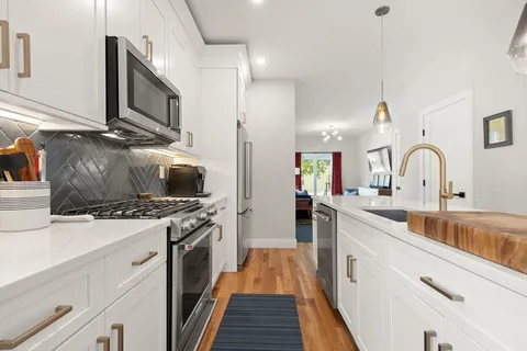 a kitchen with a sink and stainless steel appliances