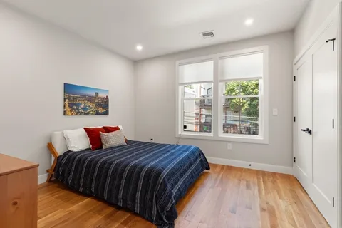a bedroom with a large bed and a window