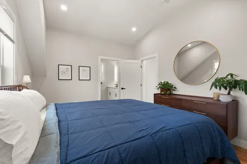 a bedroom with a bed and a chandelier