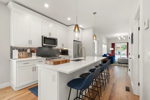 a kitchen with appliances a sink cabinets and a counter top space