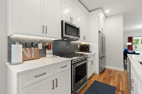 a kitchen with a stove and a refrigerator
