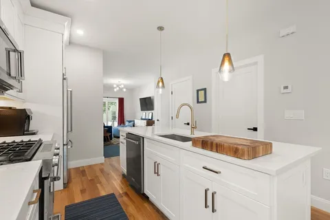 a kitchen with a sink stove and refrigerator