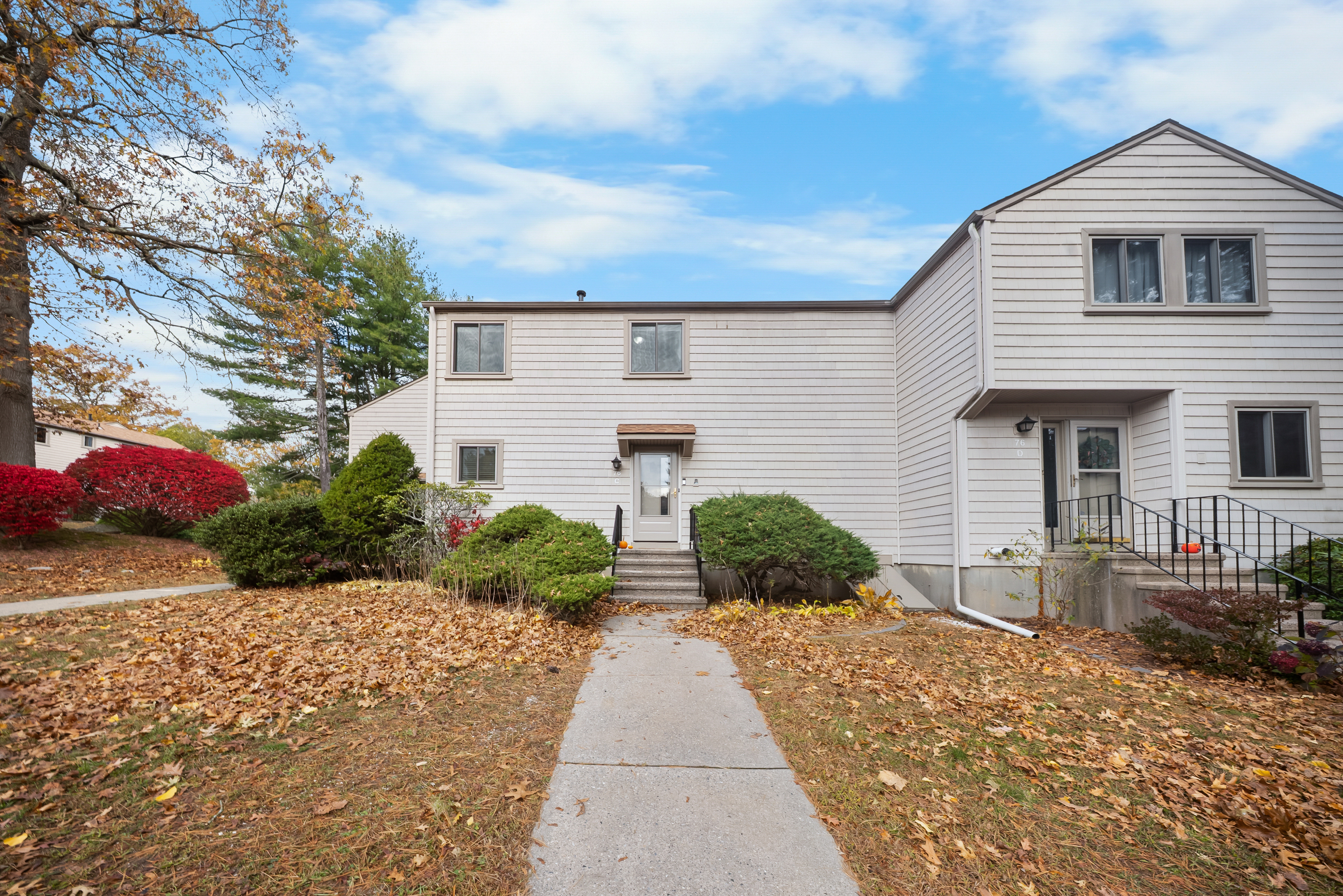 76 River Bend Road, Unit C Stratford, CT 06614 - Photo 1 of 26 a front view of a house with a yard and potted plants