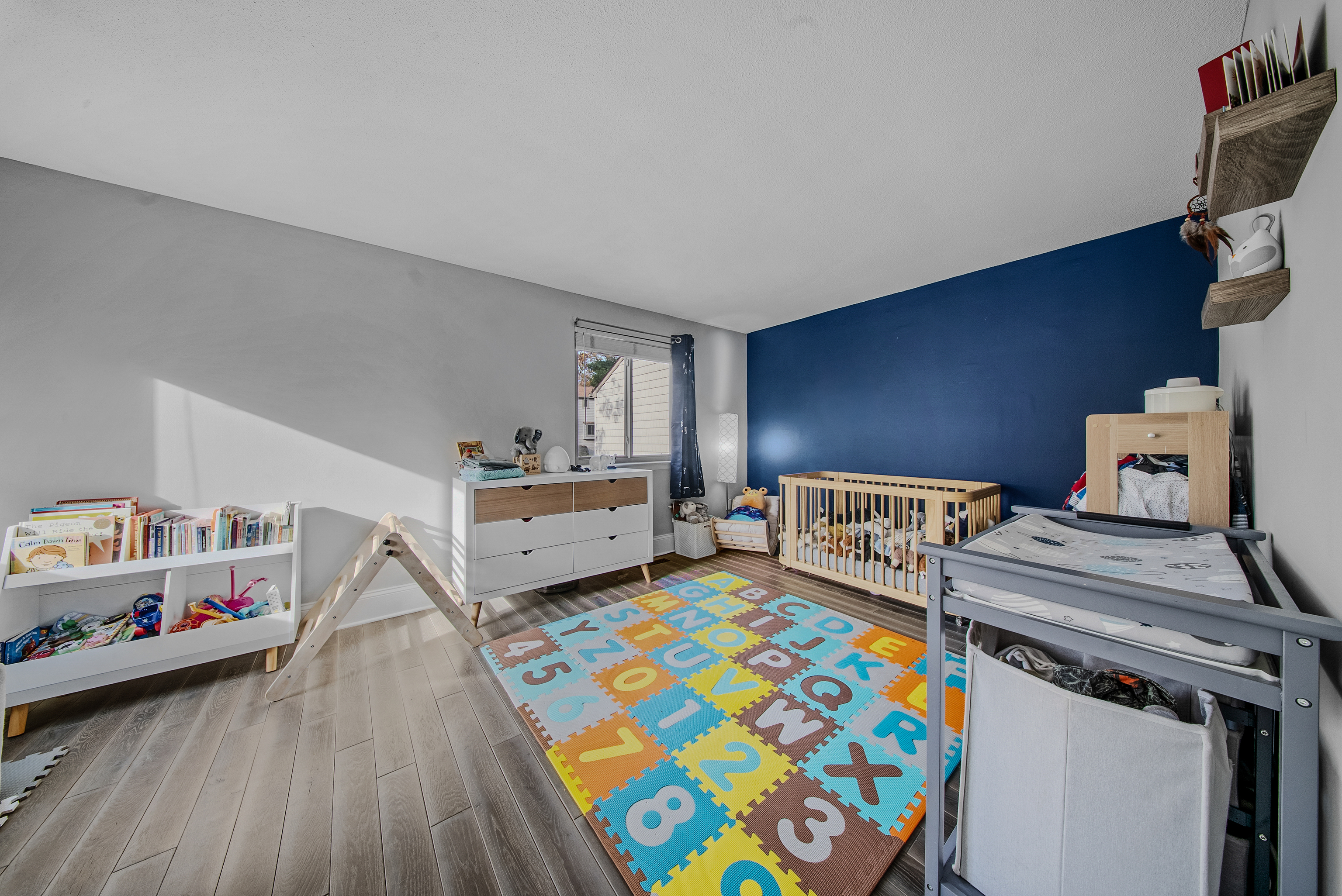 76 River Bend Road, Unit C Stratford, CT 06614 - Photo 14 of 26 a bedroom with furniture and a wooden floor