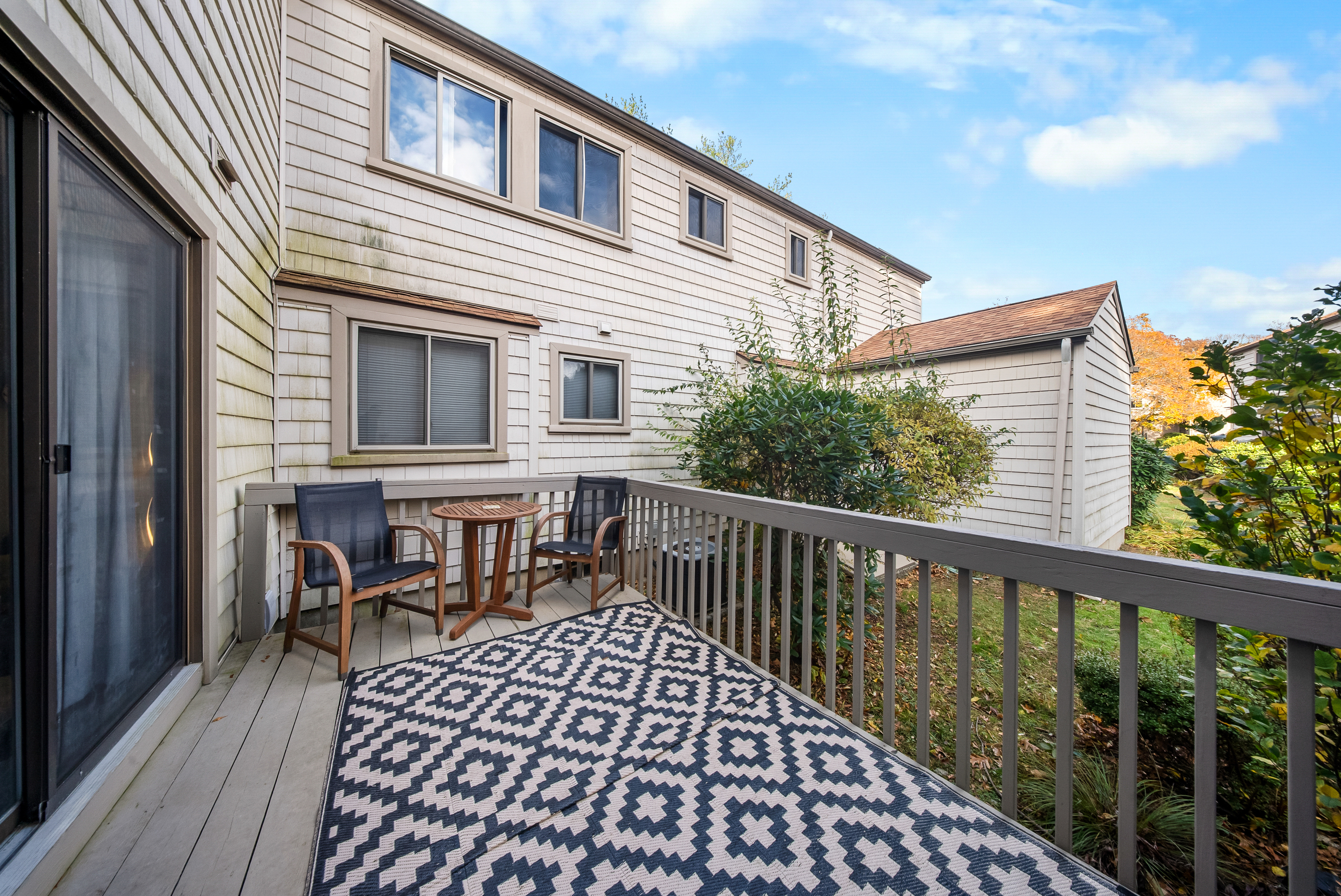 76 River Bend Road, Unit C Stratford, CT 06614 - Photo 20 of 26 a view of a house with wooden deck and furniture