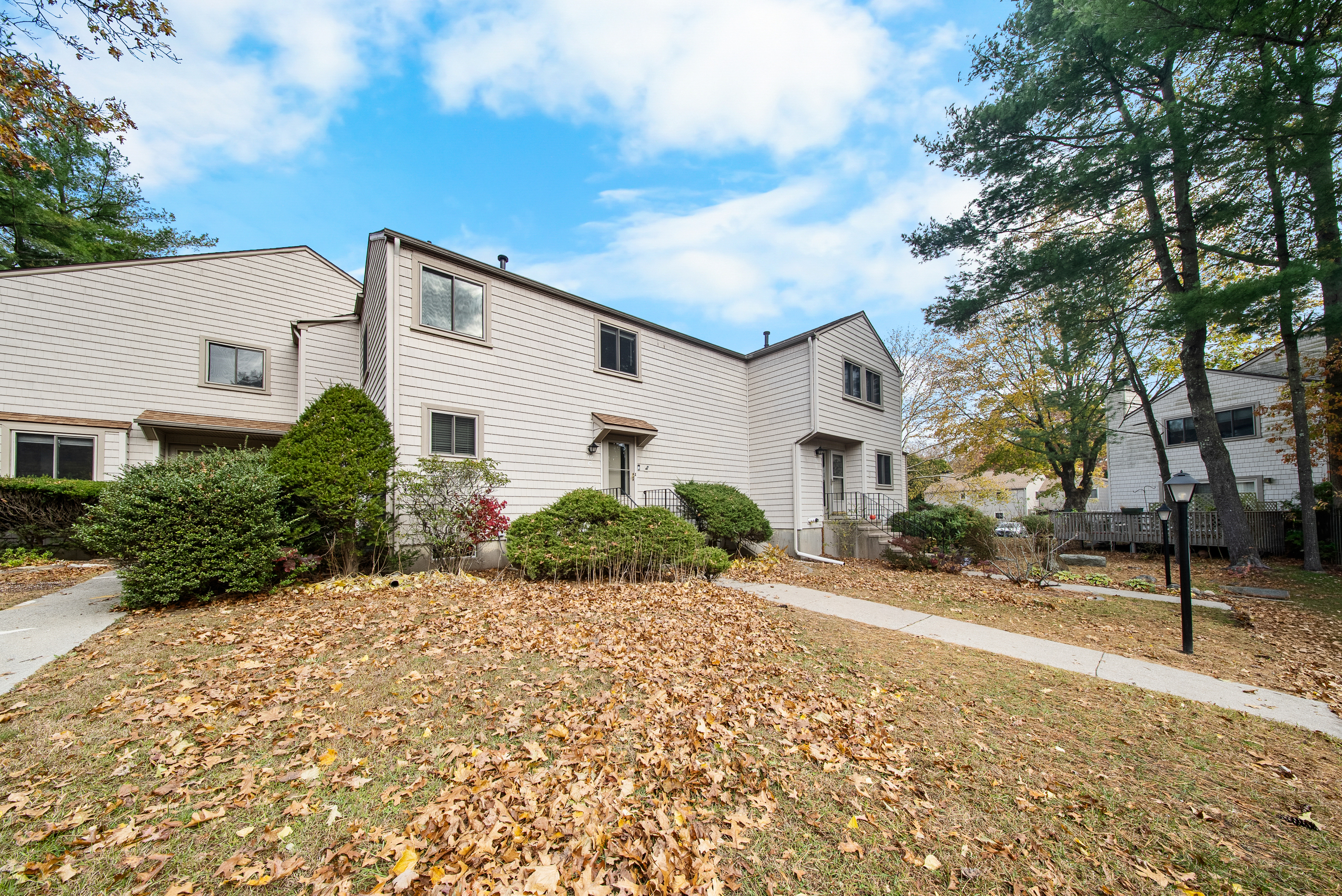 76 River Bend Road, Unit C Stratford, CT 06614 - Photo 21 of 26 a front view of a house with a yard