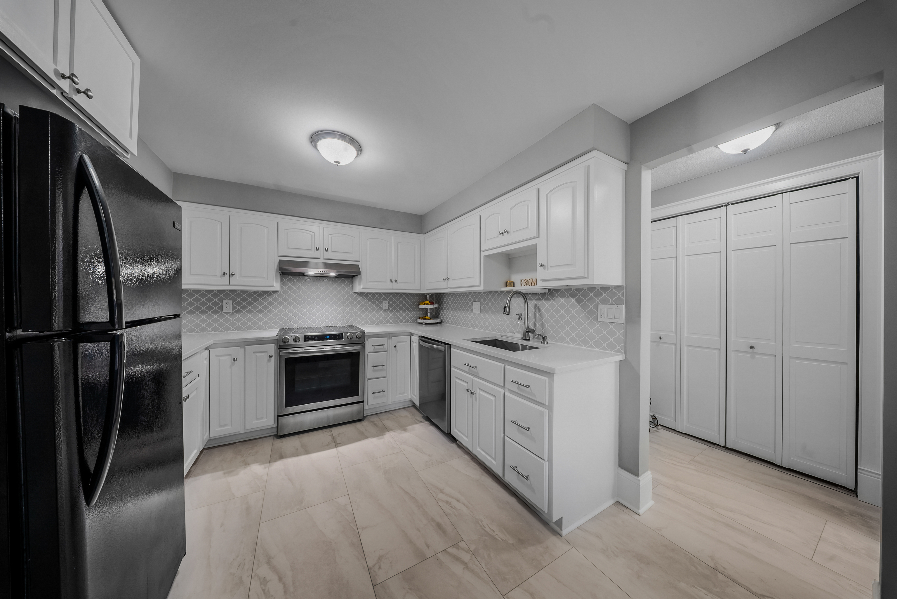 76 River Bend Road, Unit C Stratford, CT 06614 - Photo 3 of 26 a kitchen with stainless steel appliances granite countertop a stove a sink and a refrigerator