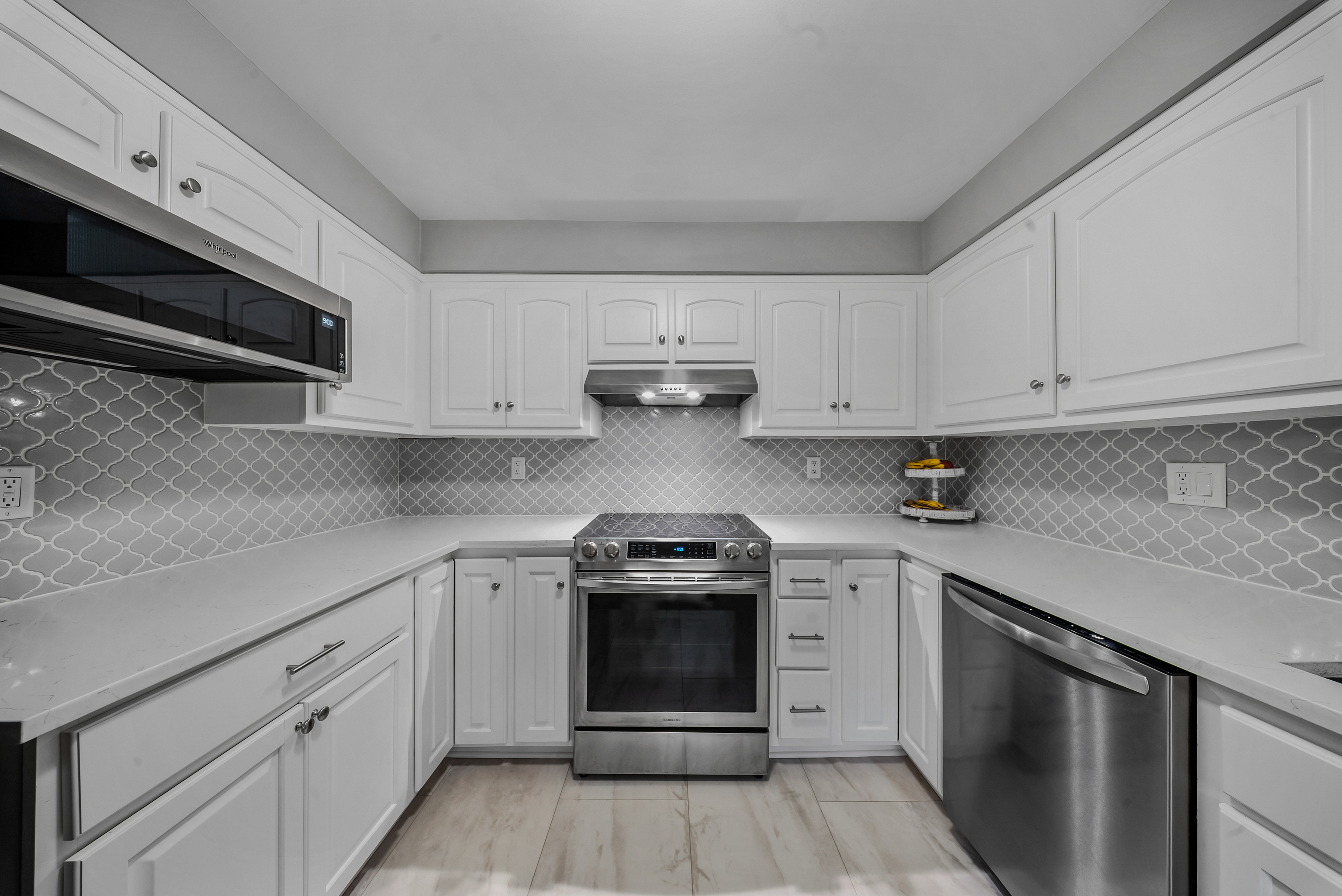 76 River Bend Road, Unit C Stratford, CT 06614 - Photo 5 of 26 a kitchen with white cabinets and appliances