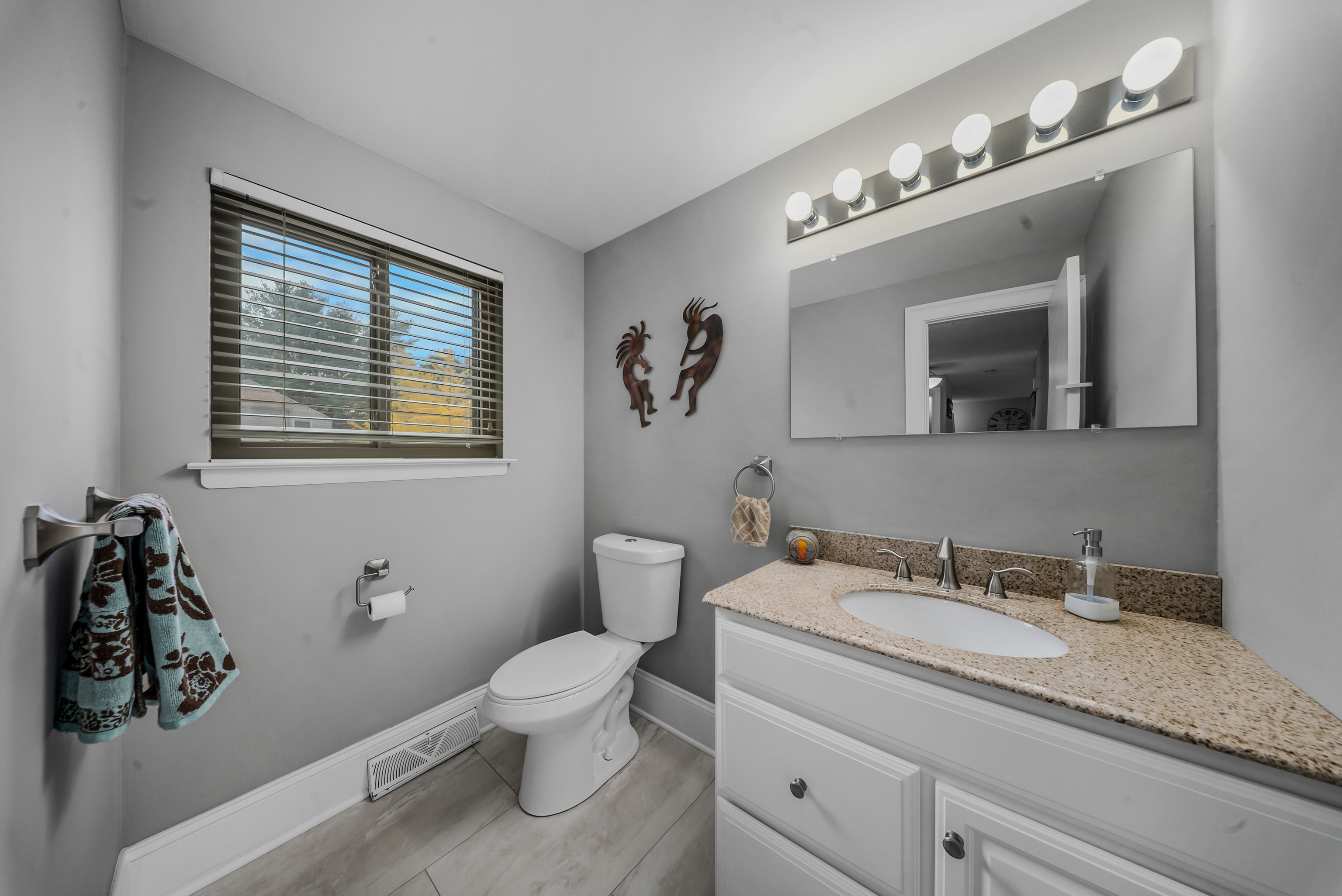 76 River Bend Road, Unit C Stratford, CT 06614 - Photo 7 of 26 a bathroom with a granite countertop sink a toilet and mirror