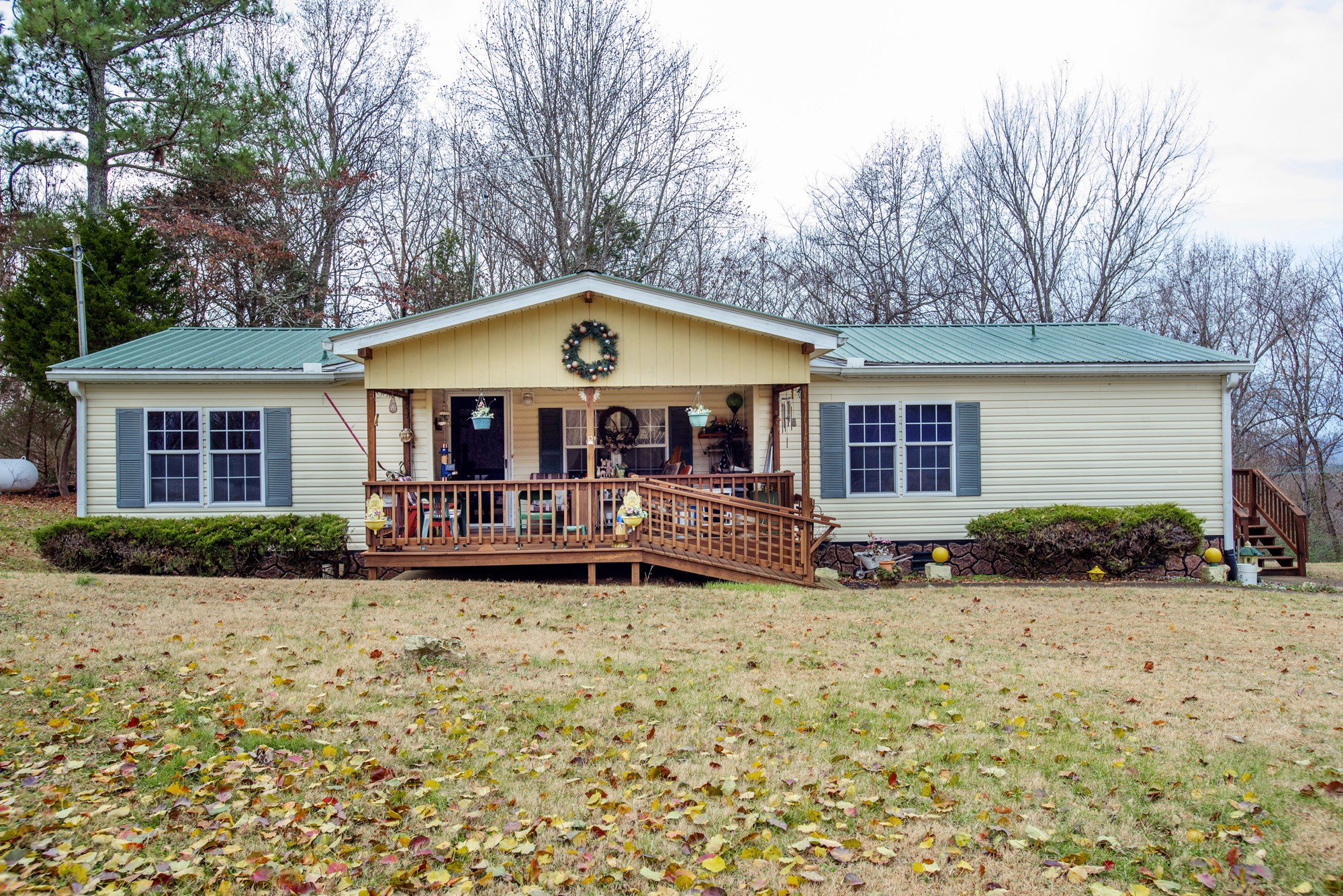 a front view of a house with yard porch and furniture
