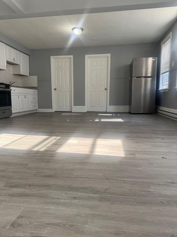 170 Warren Court, Unit 1 Lowell, MA 01852 - Photo 5 of 5 a view of empty room with wooden floor and window