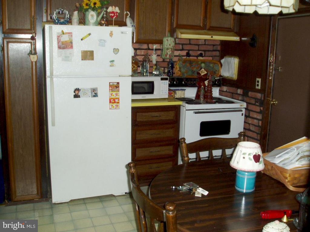 68 Ridgewood Manor Manheim, PA 17545 - Photo 4 of 4 a kitchen with stainless steel appliances a stove a table and chairs