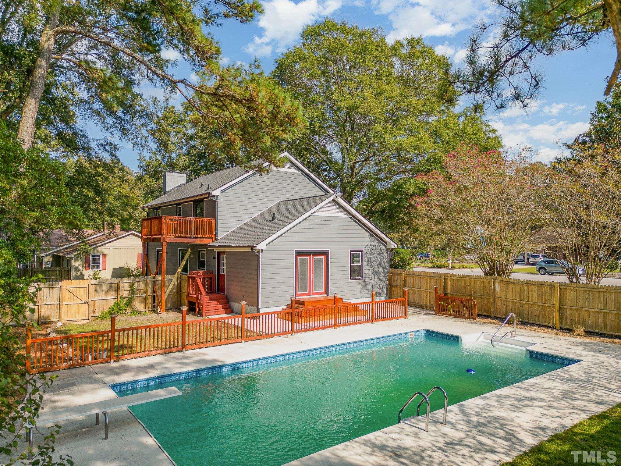a view of a house with a backyard and a tree