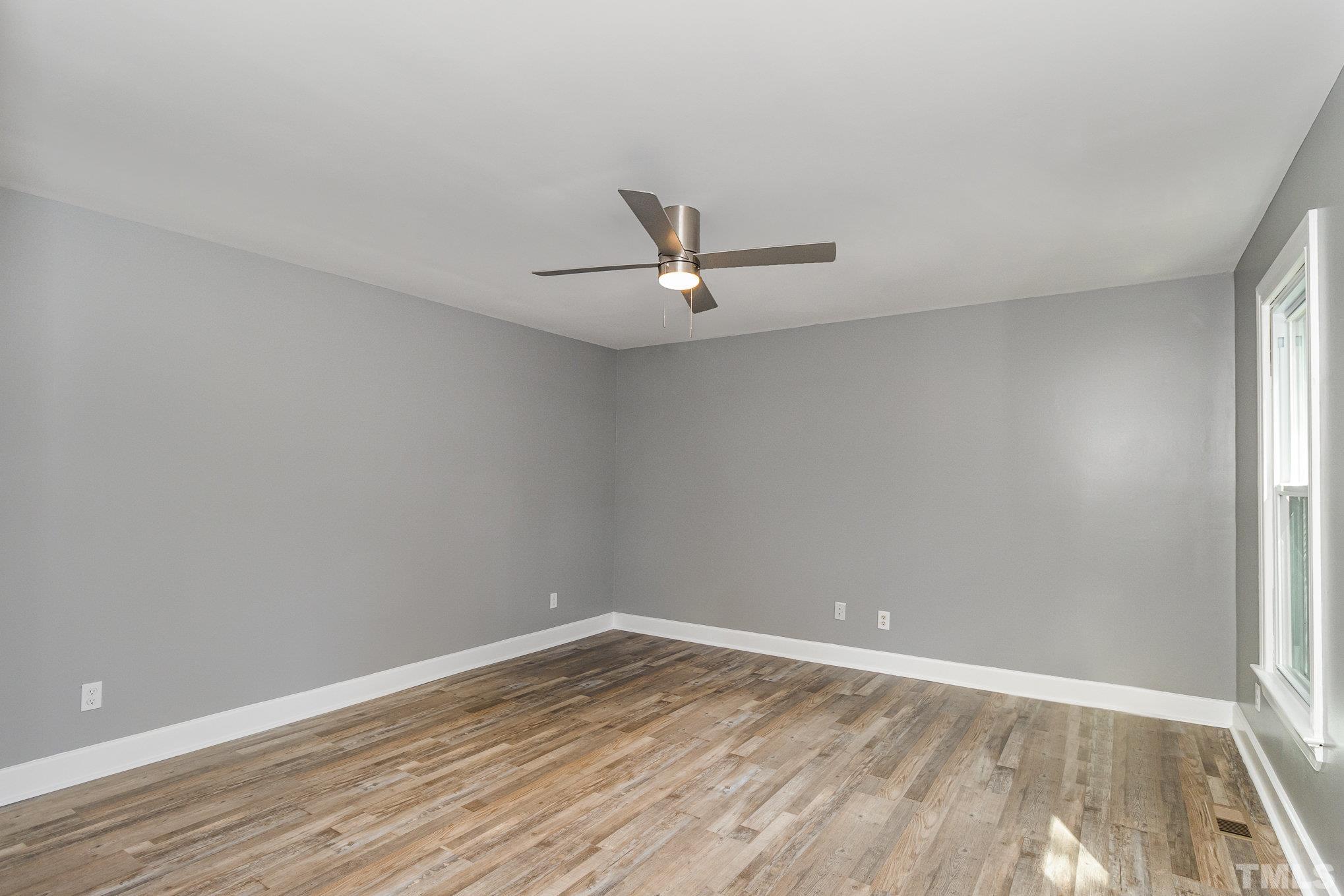14 Eden Drive Smithfield, NC 27577 - Photo 17 of 37 a view of a room with wooden floor and a ceiling fan