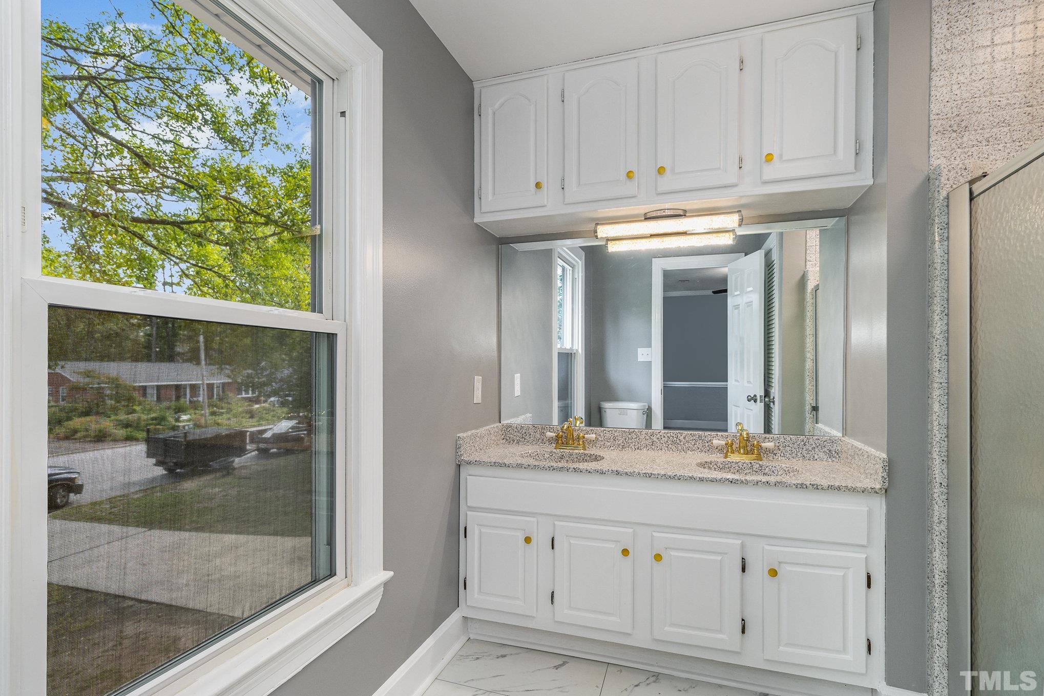 14 Eden Drive Smithfield, NC 27577 - Photo 22 of 37 a bathroom with a granite countertop double vanity and a mirror