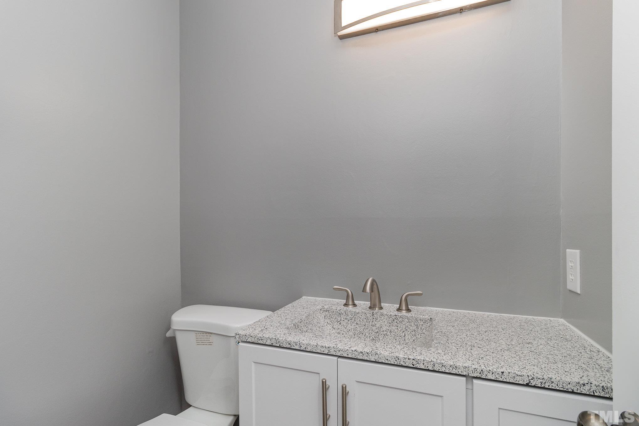 14 Eden Drive Smithfield, NC 27577 - Photo 25 of 37 a bathroom with a granite countertop toilet and sink