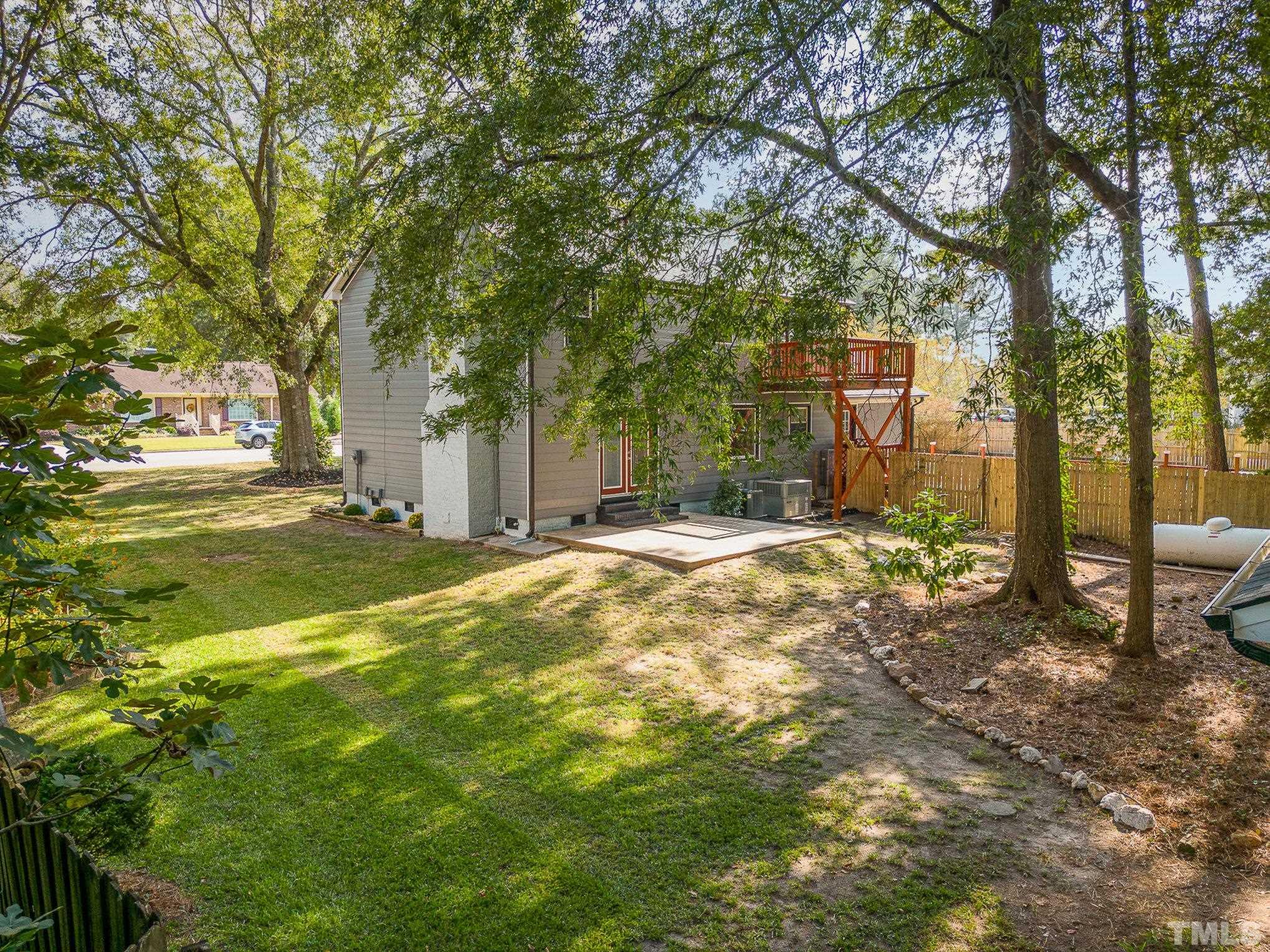14 Eden Drive Smithfield, NC 27577 - Photo 32 of 37 a view of a yard with large tree and wooden fence