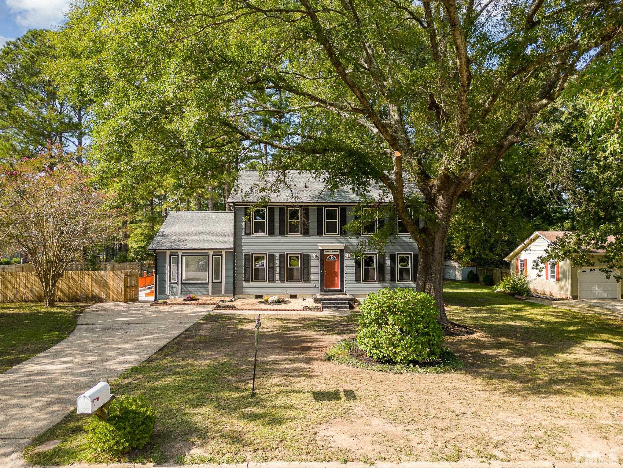 14 Eden Drive Smithfield, NC 27577 - Photo 4 of 37 a front view of a building with trees and umbrellas