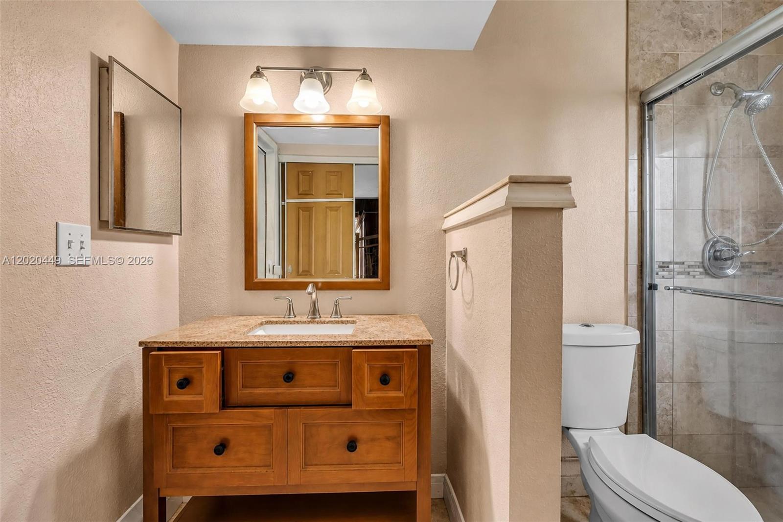 11061 Southwest 163rd Street Miami, FL 33157 - Photo 17 of 42 a bathroom with a sink a toilet and shower