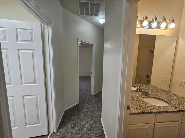 a view of a bathroom from a hallway