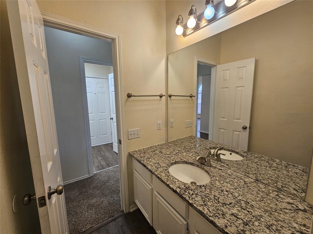 7851 Orland Park Circle Fort Worth, TX 76137 - Photo 15 of 35 a bathroom with a granite countertop sink and a mirror