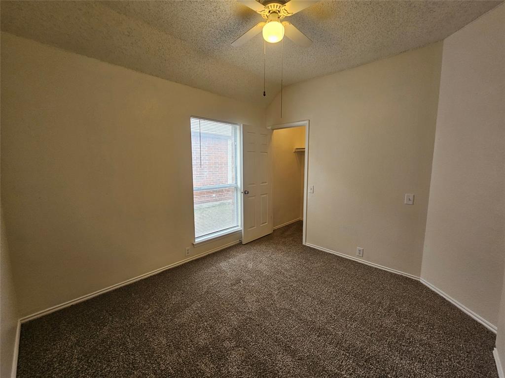 7851 Orland Park Circle Fort Worth, TX 76137 - Photo 19 of 35 an empty room with a chandelier fan and closet