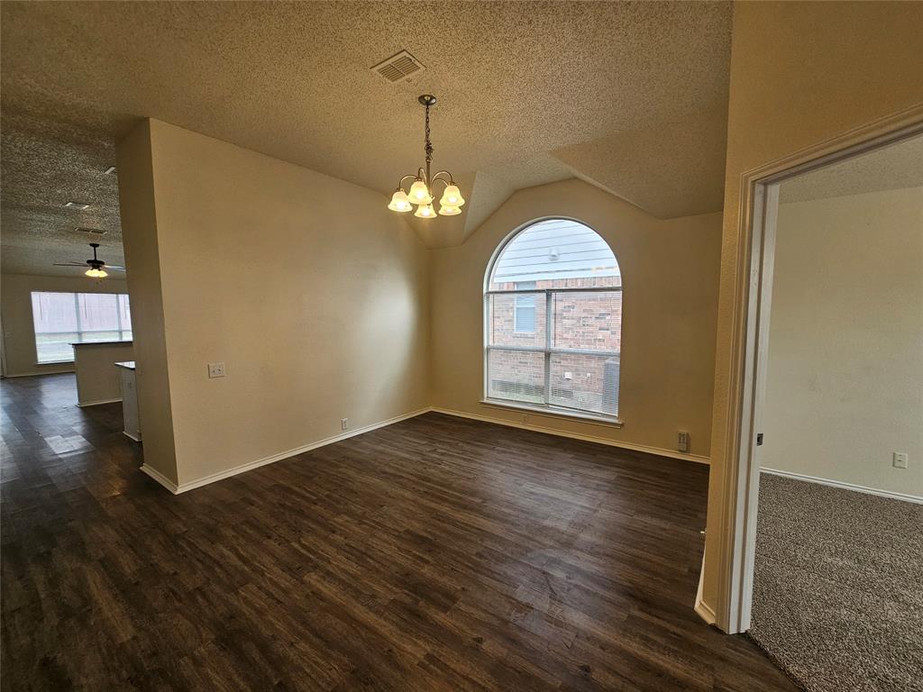 7851 Orland Park Circle Fort Worth, TX 76137 - Photo 2 of 35 an empty room with wooden floor chandelier and windows