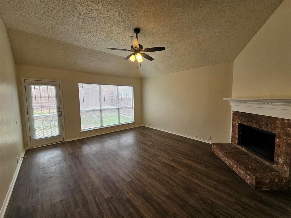 7851 Orland Park Circle Fort Worth, TX 76137 - Photo 24 of 35 a view of empty room with wooden floor and fireplace
