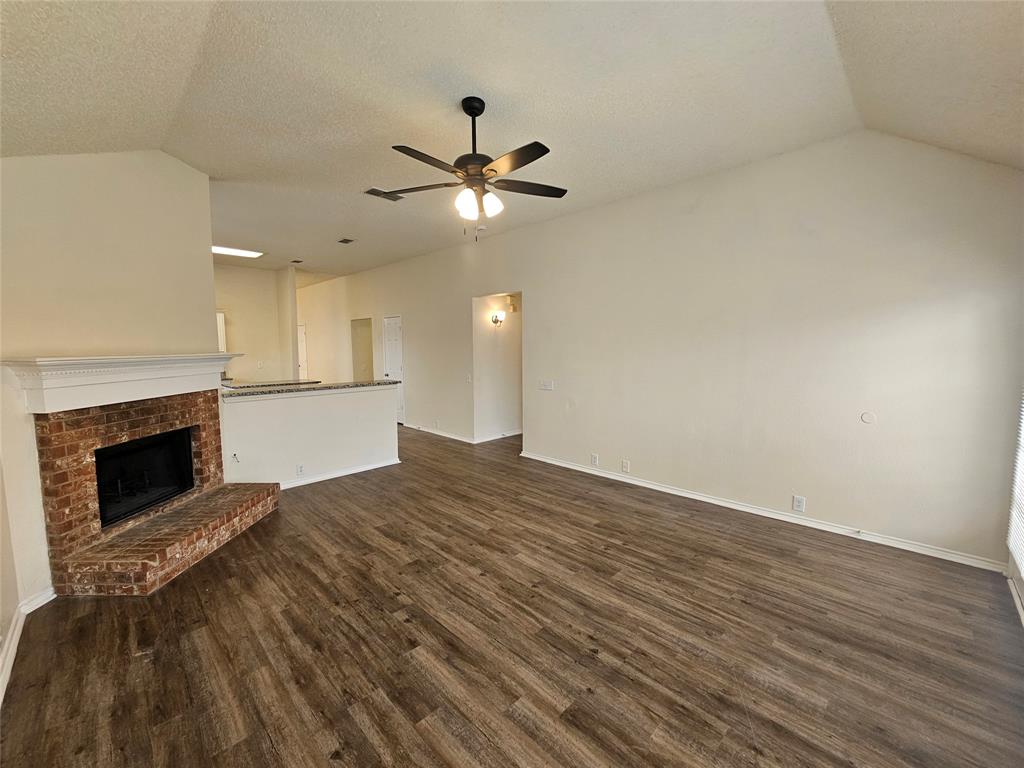 7851 Orland Park Circle Fort Worth, TX 76137 - Photo 25 of 35 a view of empty room with wooden floor and fireplace