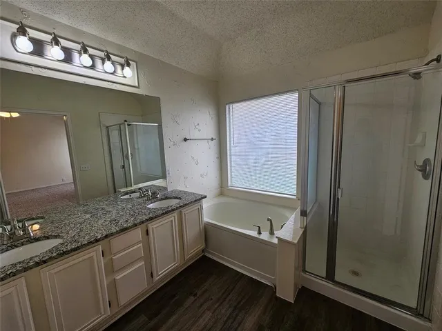 a bathroom with a granite countertop sink a vanity and mirror