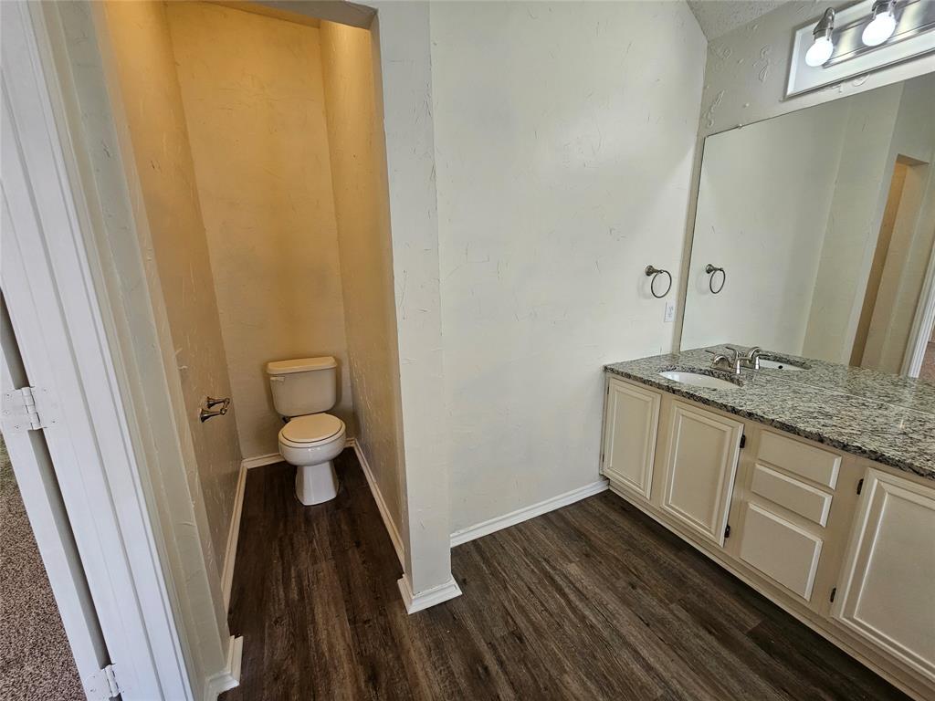 7851 Orland Park Circle Fort Worth, TX 76137 - Photo 32 of 35 a bathroom with a granite countertop sink and a mirror