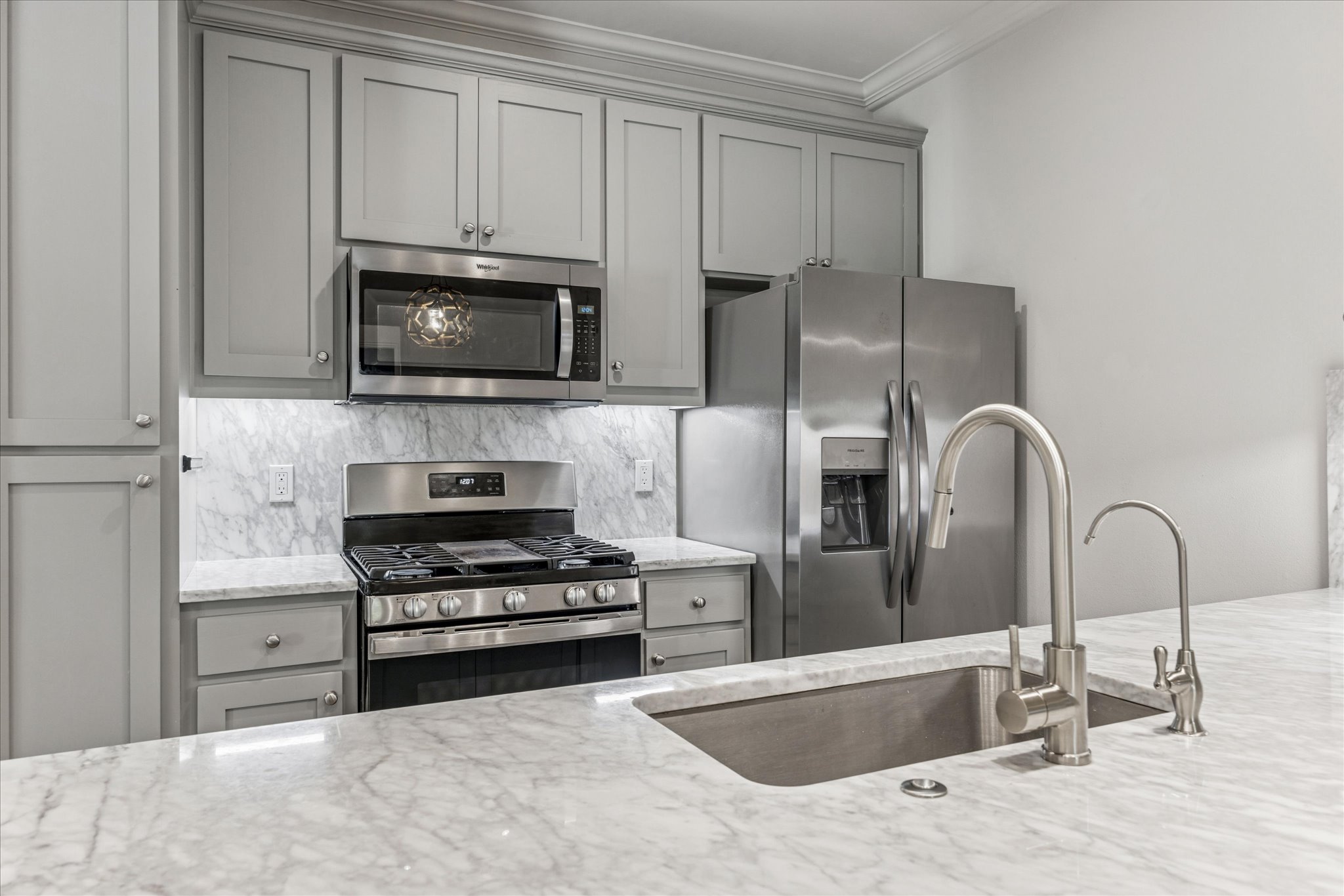 3303 Pecos Street, Unit B Austin, TX 78703 - Photo 12 of 30 a kitchen with granite countertop a sink and stainless steel appliances