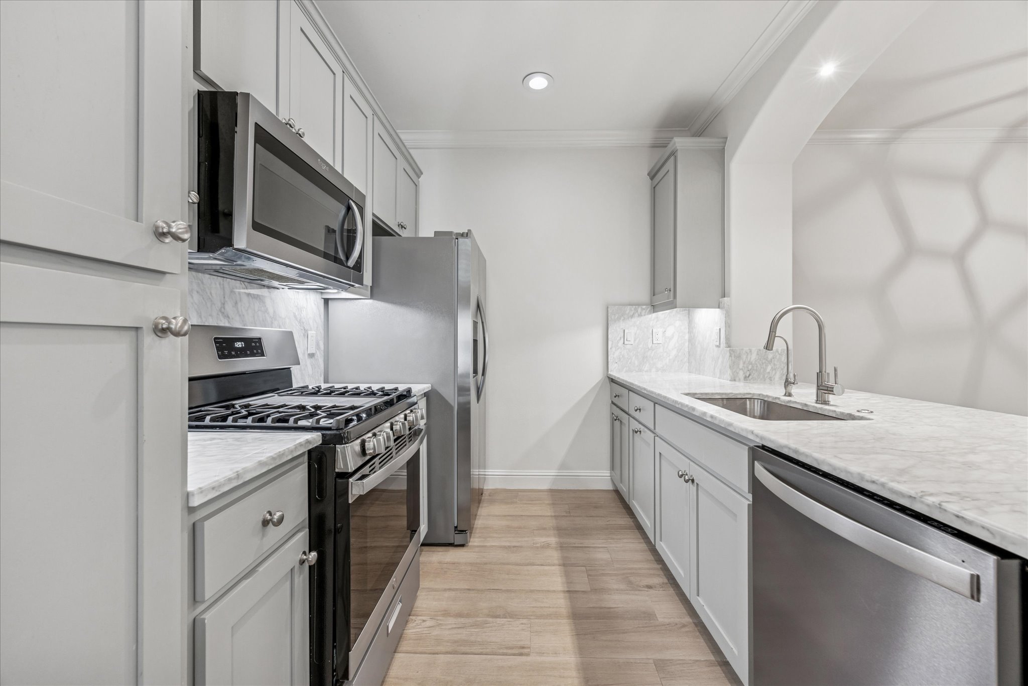 3303 Pecos Street, Unit B Austin, TX 78703 - Photo 13 of 30 a kitchen with stainless steel appliances granite countertop a sink stove and refrigerator