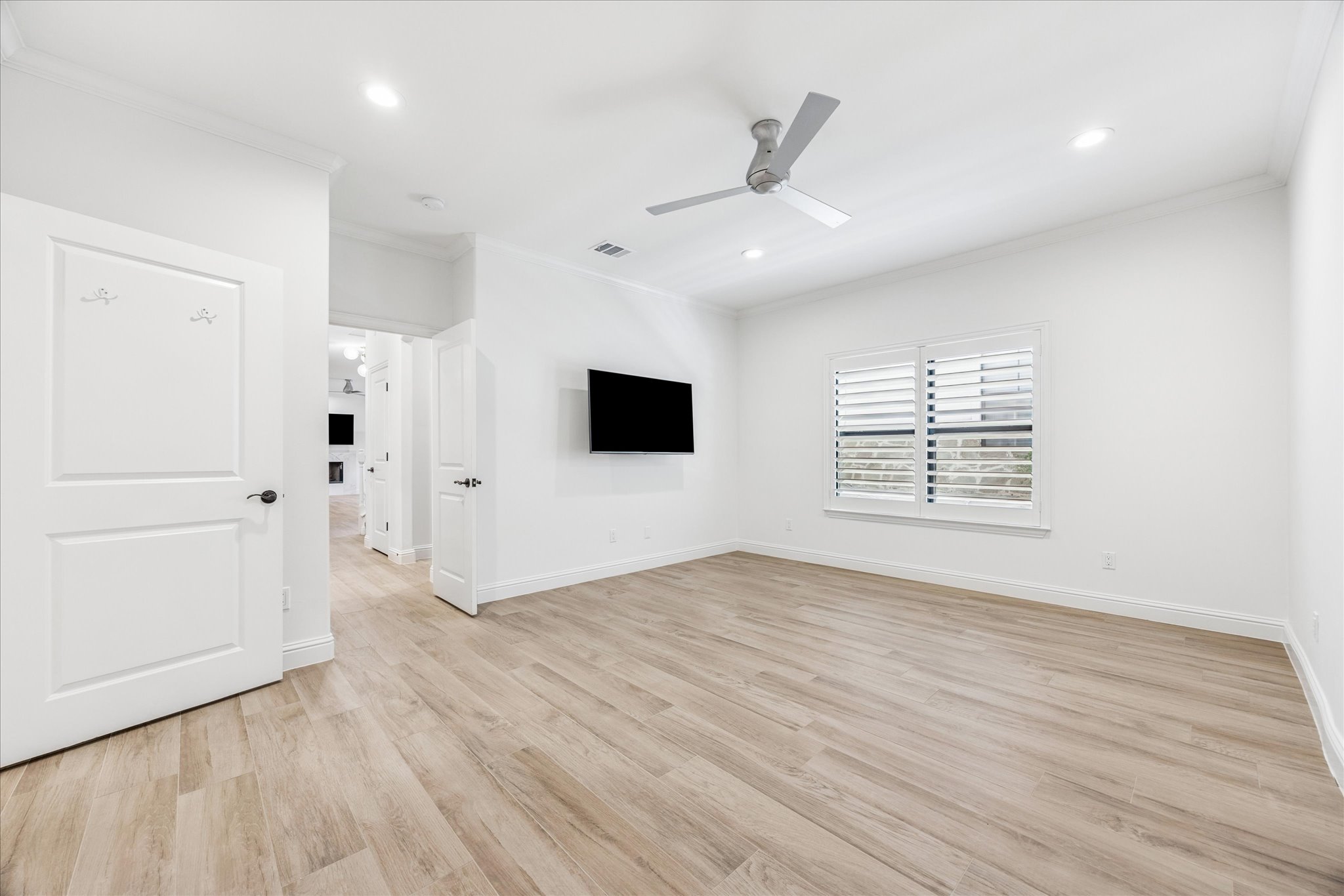 3303 Pecos Street, Unit B Austin, TX 78703 - Photo 16 of 30 an empty room with wooden floor cabinet and windows