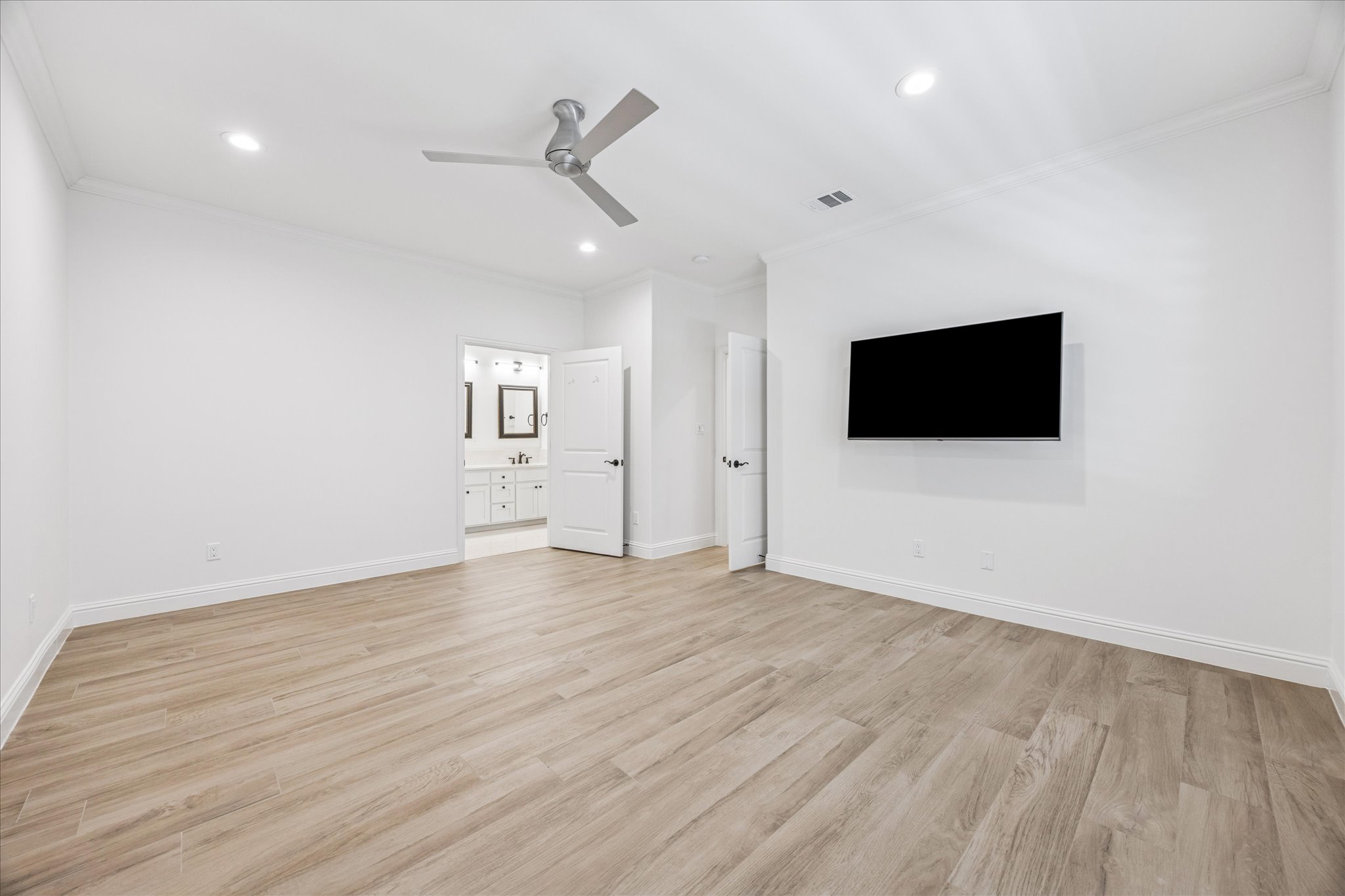 3303 Pecos Street, Unit B Austin, TX 78703 - Photo 17 of 30 a view of an empty room with wooden floor and a ceiling fan
