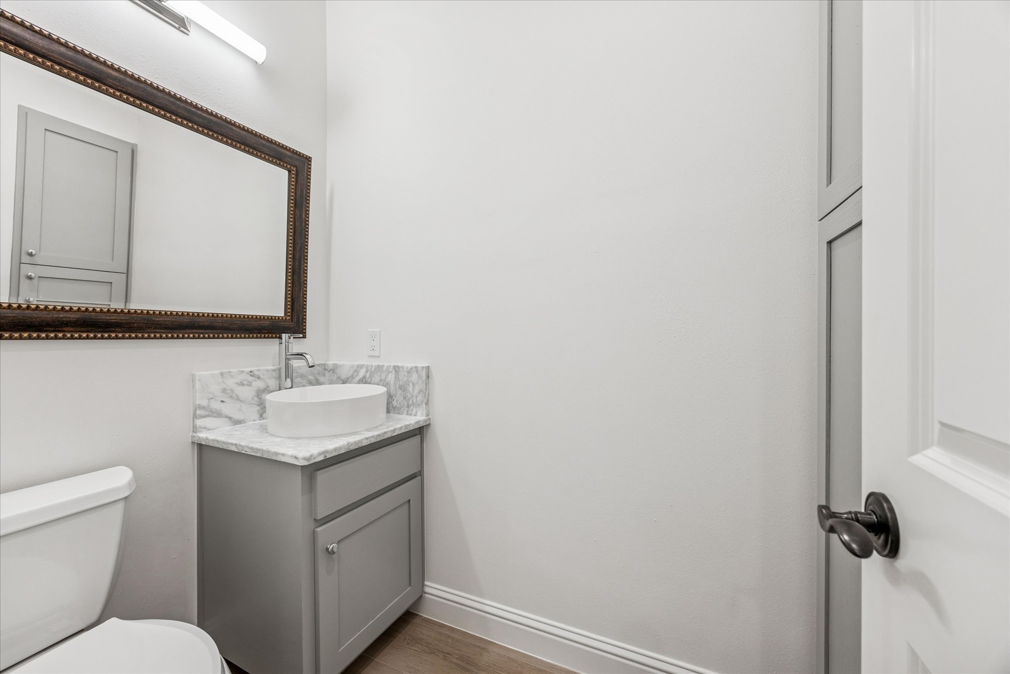 3303 Pecos Street, Unit B Austin, TX 78703 - Photo 28 of 30 a bathroom with a toilet sink and mirror