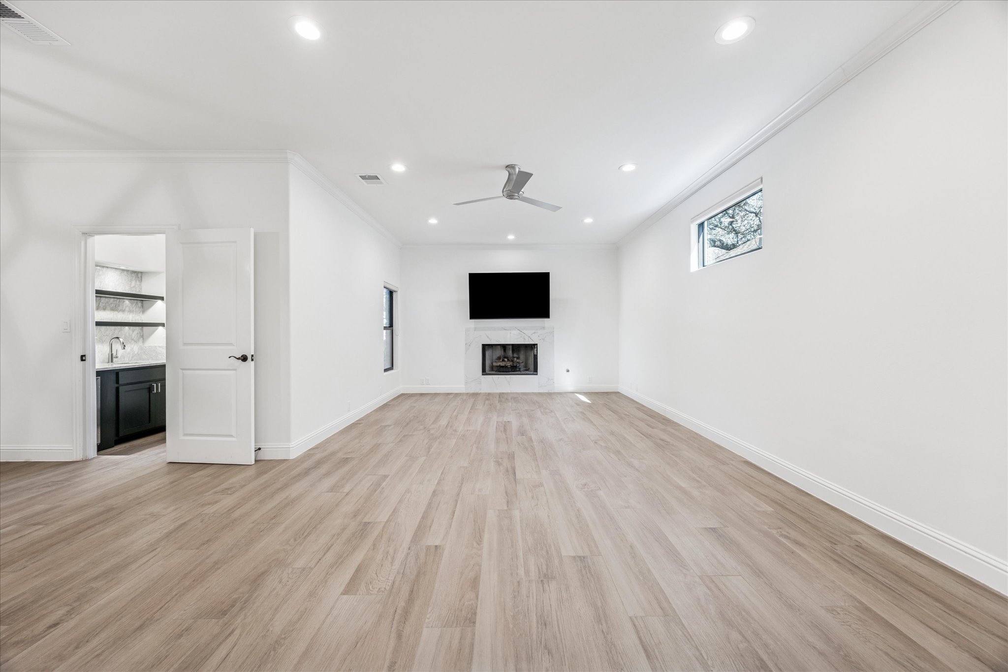 3303 Pecos Street, Unit B Austin, TX 78703 - Photo 6 of 30 an empty room with wooden floor and windows