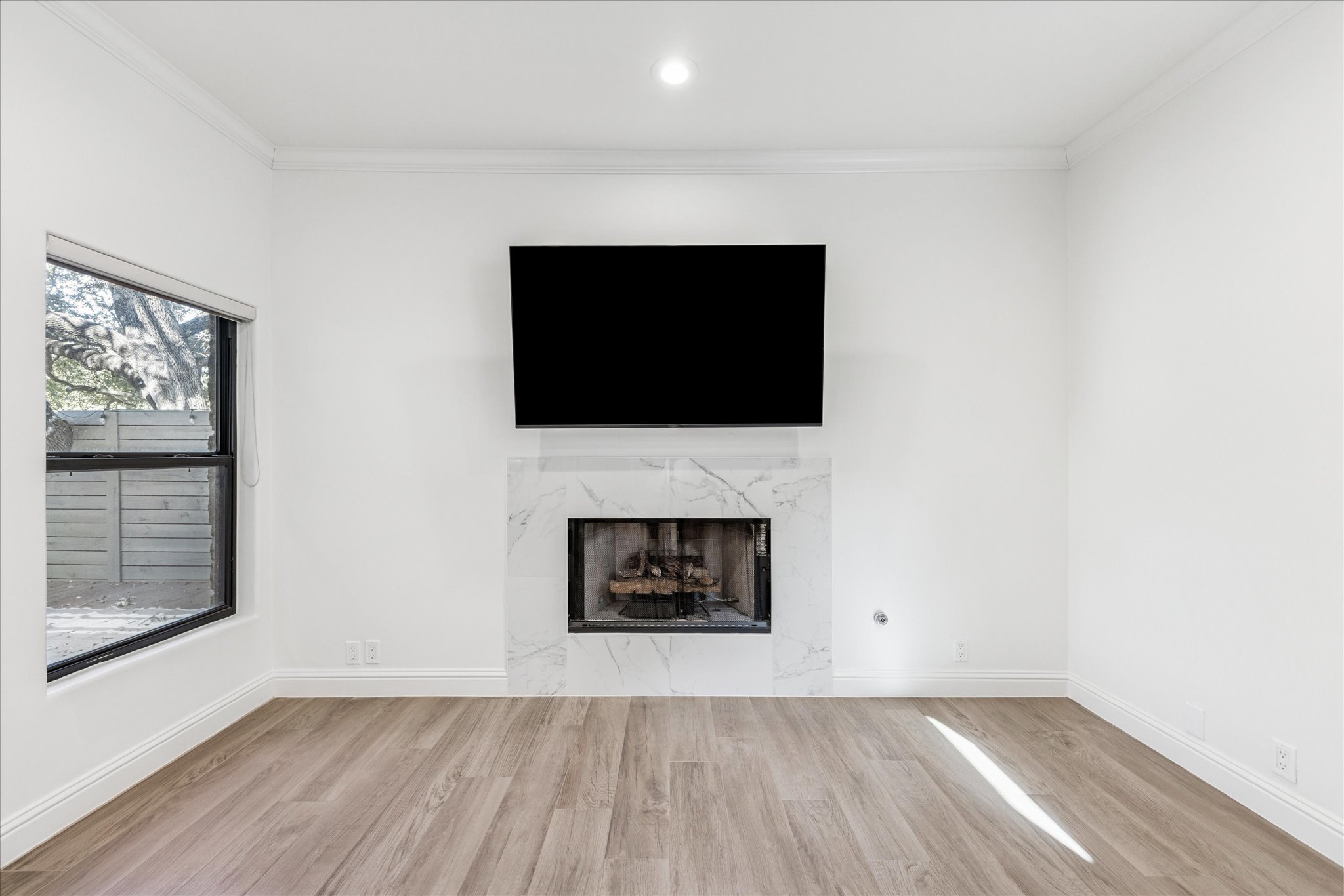 3303 Pecos Street, Unit B Austin, TX 78703 - Photo 7 of 30 a living room with a fireplace and a flat screen tv