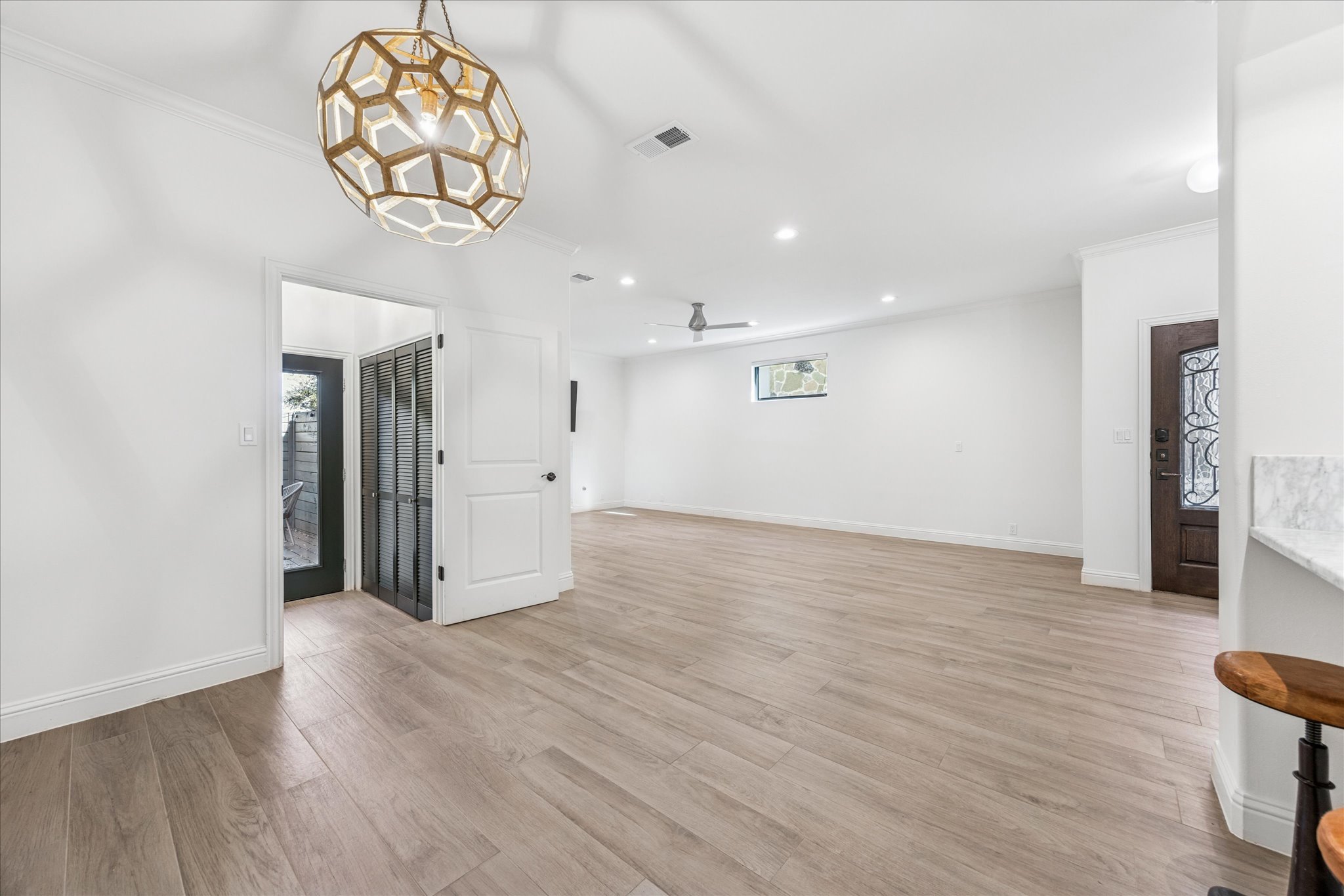 3303 Pecos Street, Unit B Austin, TX 78703 - Photo 10 of 30 a view of a hallway with wooden floor and a chandelier