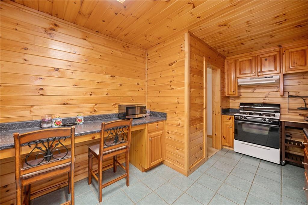 5 Tally Mountain Road North Jasper, GA 30143 - Photo 18 of 58 a kitchen with stainless steel appliances kitchen island granite countertop a stove and cabinets