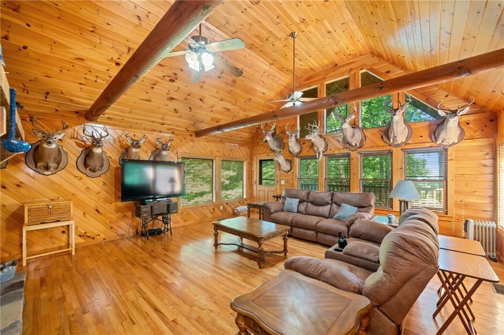 5 Tally Mountain Road North Jasper, GA 30143 - Photo 21 of 58 a living room with furniture a flat screen tv and a floor to ceiling window