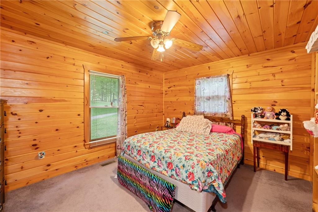 5 Tally Mountain Road North Jasper, GA 30143 - Photo 24 of 58 a bedroom with a bed and a walk in closet