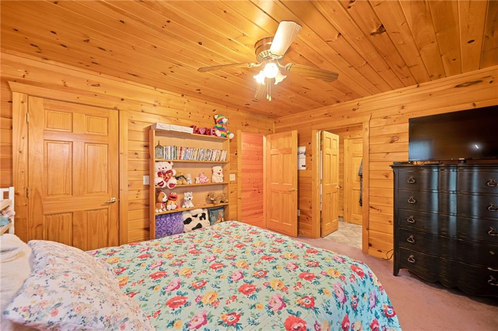 5 Tally Mountain Road North Jasper, GA 30143 - Photo 25 of 58 a bedroom with a bed dresser and a flat tv screen