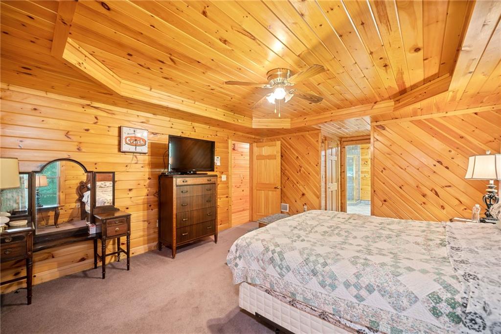 5 Tally Mountain Road North Jasper, GA 30143 - Photo 29 of 58 a bedroom with a bed a flat screen tv and balcony view