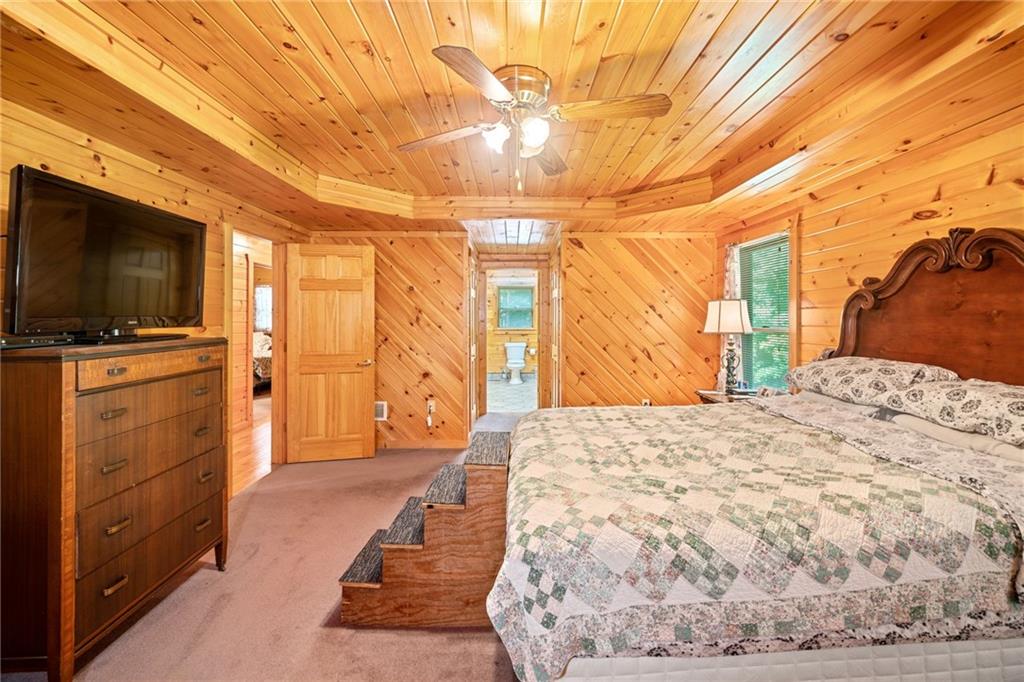 5 Tally Mountain Road North Jasper, GA 30143 - Photo 30 of 58 a bedroom with a bed and a flat tv screen on dresser