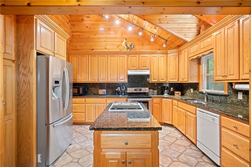 5 Tally Mountain Road North Jasper, GA 30143 - Photo 36 of 58 a kitchen with stainless steel appliances granite countertop a stove a sink and a refrigerator