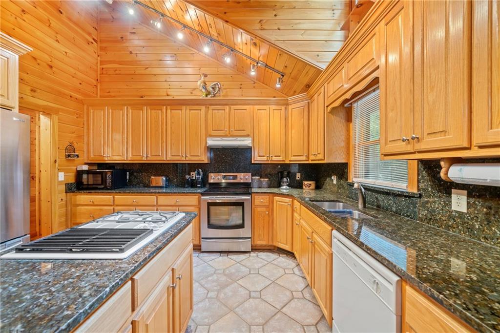 5 Tally Mountain Road North Jasper, GA 30143 - Photo 39 of 58 a kitchen with stainless steel appliances granite countertop a sink and cabinets
