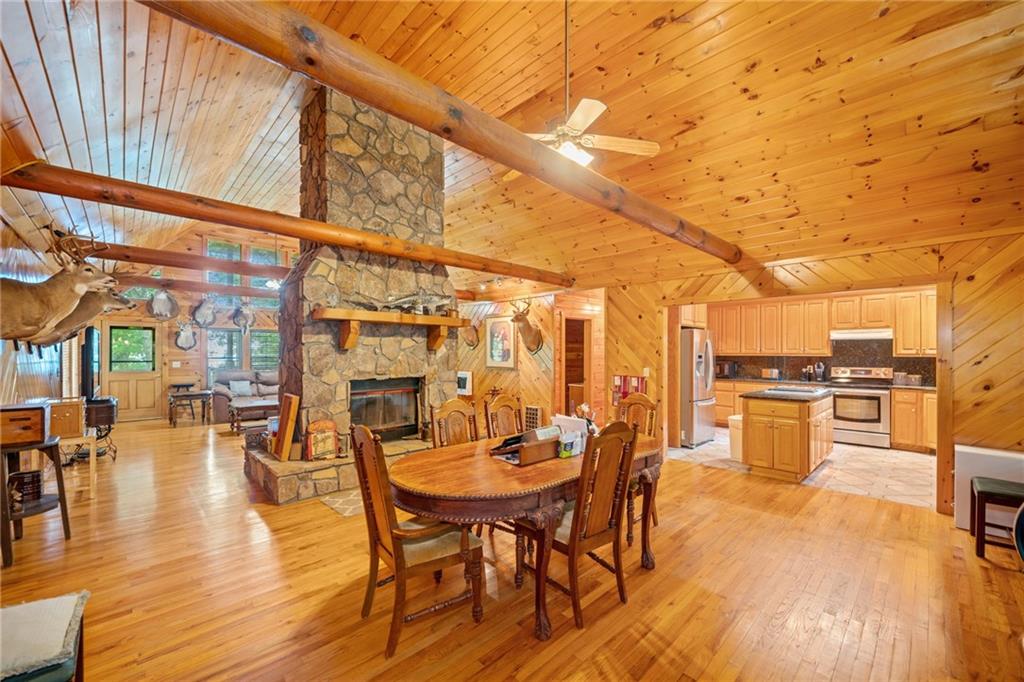 5 Tally Mountain Road North Jasper, GA 30143 - Photo 41 of 58 a view of a patio with dining table and chairs with wooden floor