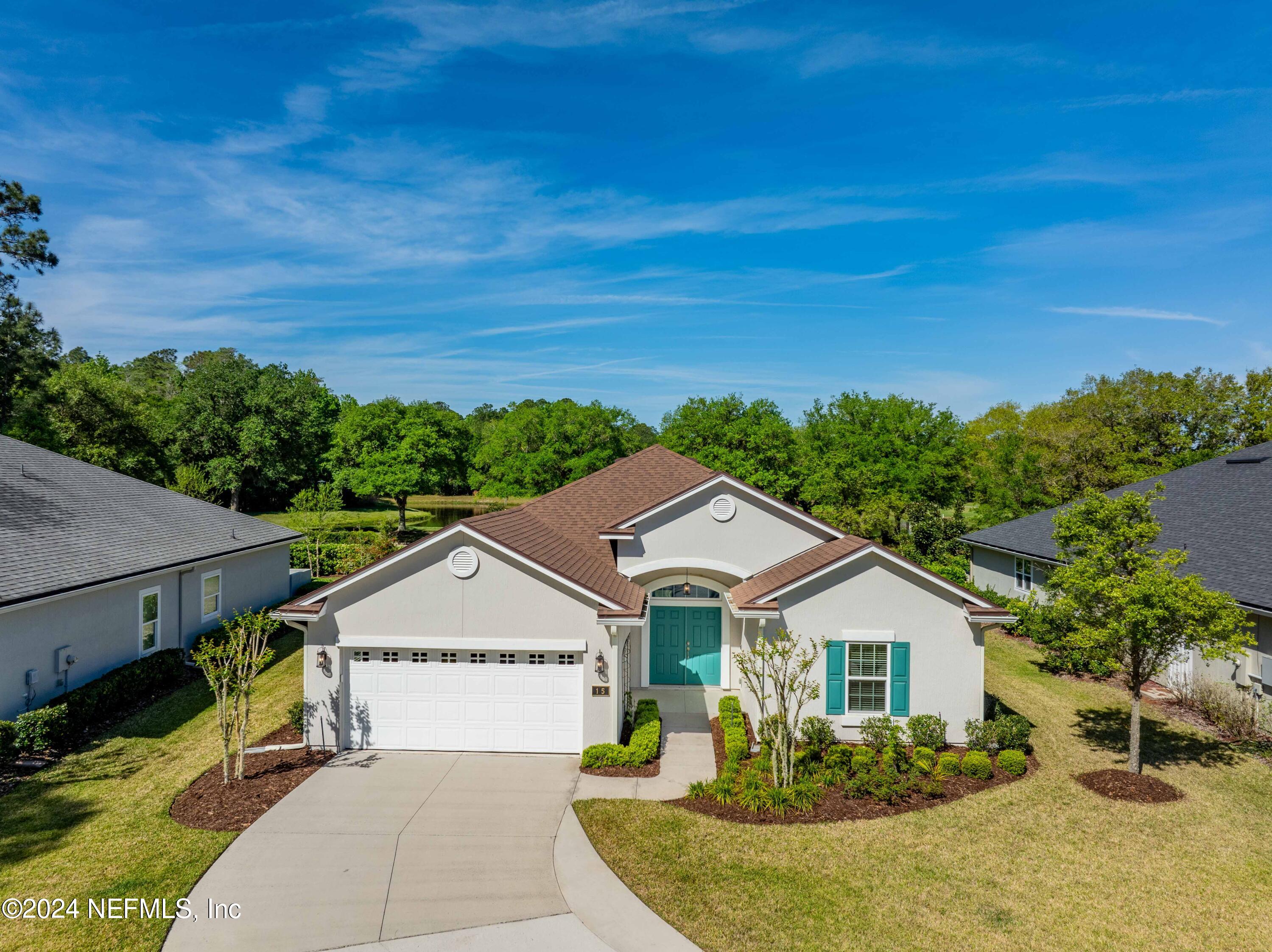 a view of a big house with wooden fence