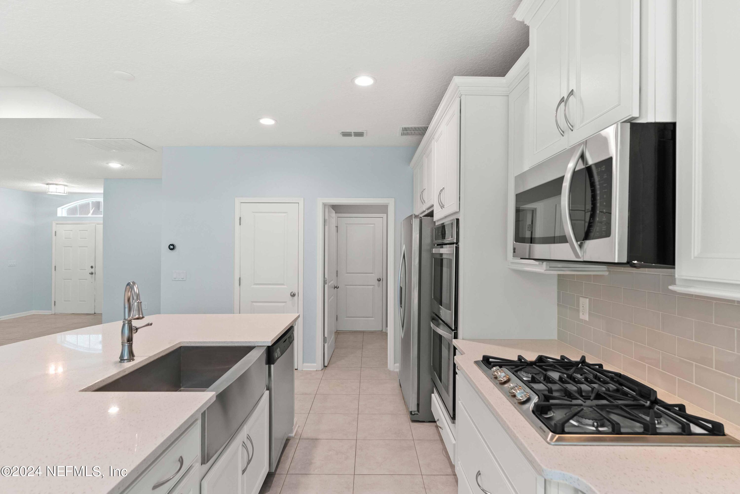 15 Greenview Lane St. Augustine, FL 32092 - Photo 12 of 41 a kitchen with stainless steel appliances a sink a stove and a refrigerator